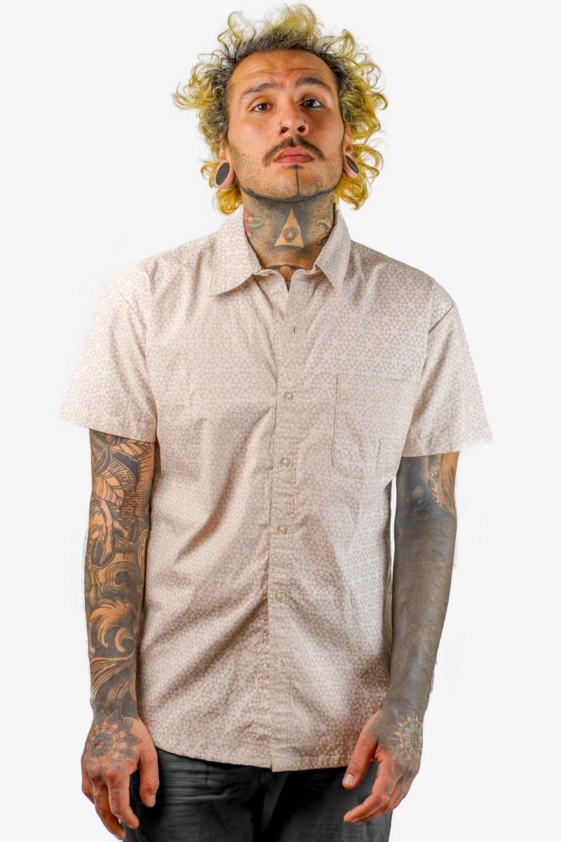 Beige Solar Grid, a uniquely designed short-sleeved button-up shirt for men, is available from Avanyah's online store and showcases wearable screen-printed art that is ideal for festival fashion and alternative statement lovers